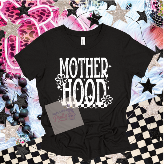 Black t-shirt with 'MOTHERHOOD' text on a colorful starry background
